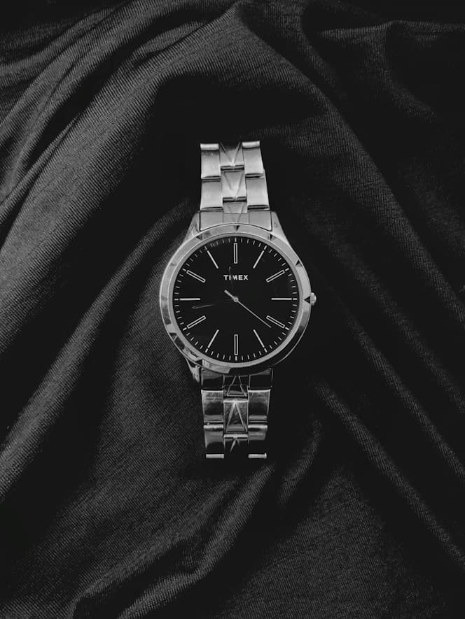 Silver Timex watch on draped fabric